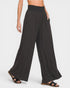 Black wide-leg pants worn by a person on a white background