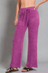 Person wearing purple pants on a gray background
