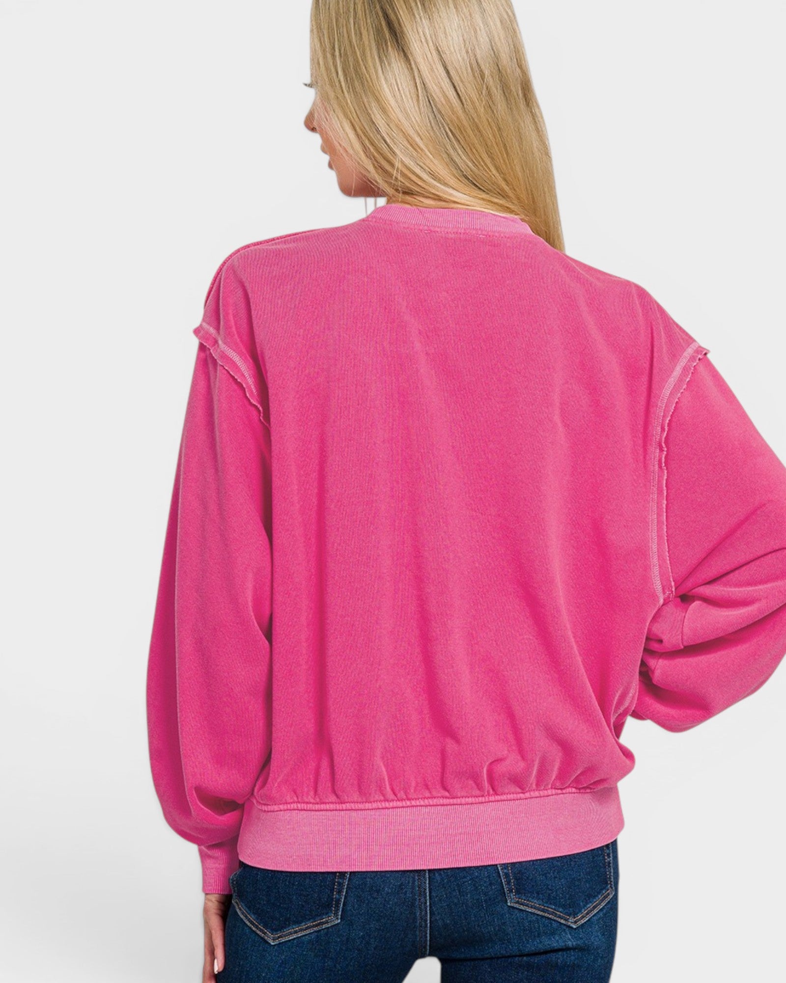 Person wearing a pink sweatshirt on a white background
