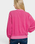 Person wearing a pink sweatshirt on a white background