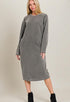 Woman wearing a gray dress with long sleeves on a plain background