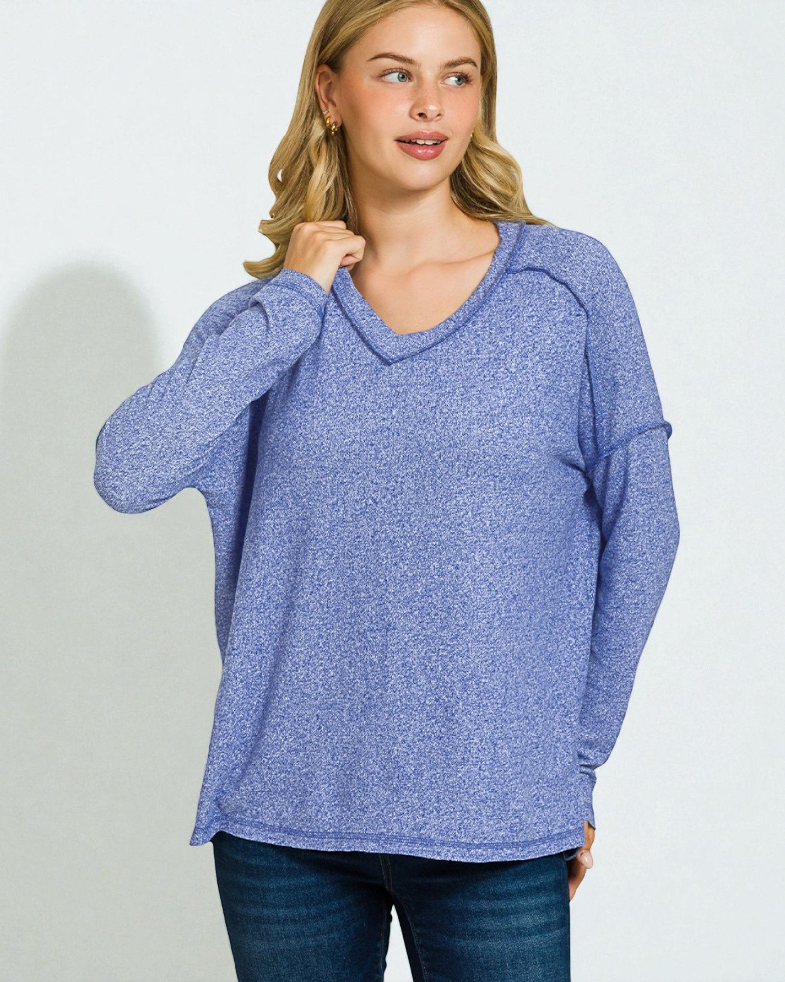 Woman wearing a blue sweater against a plain background