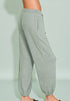Gray jogger pants worn by a person on a light green background