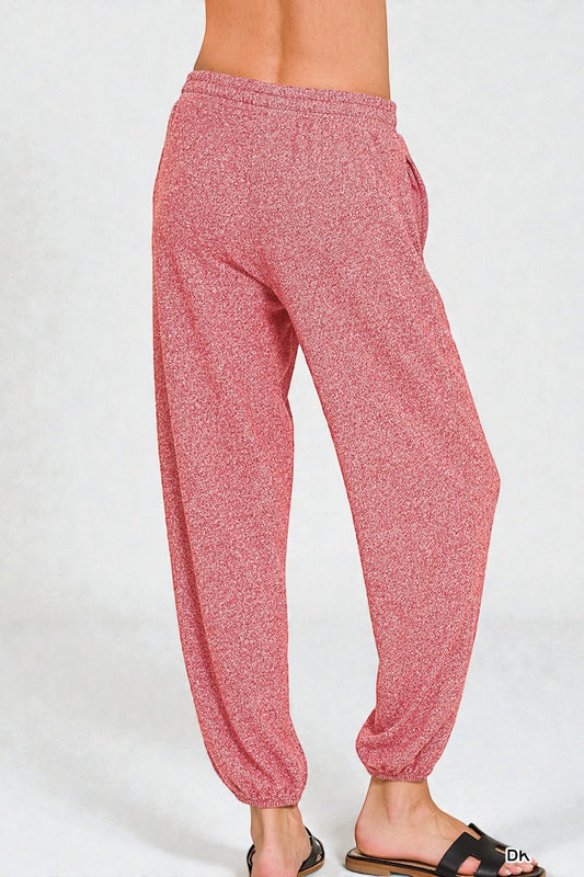 Pink marled jogger pants on a white background
