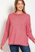 Woman wearing a pink long-sleeve top with a pocket on a white background