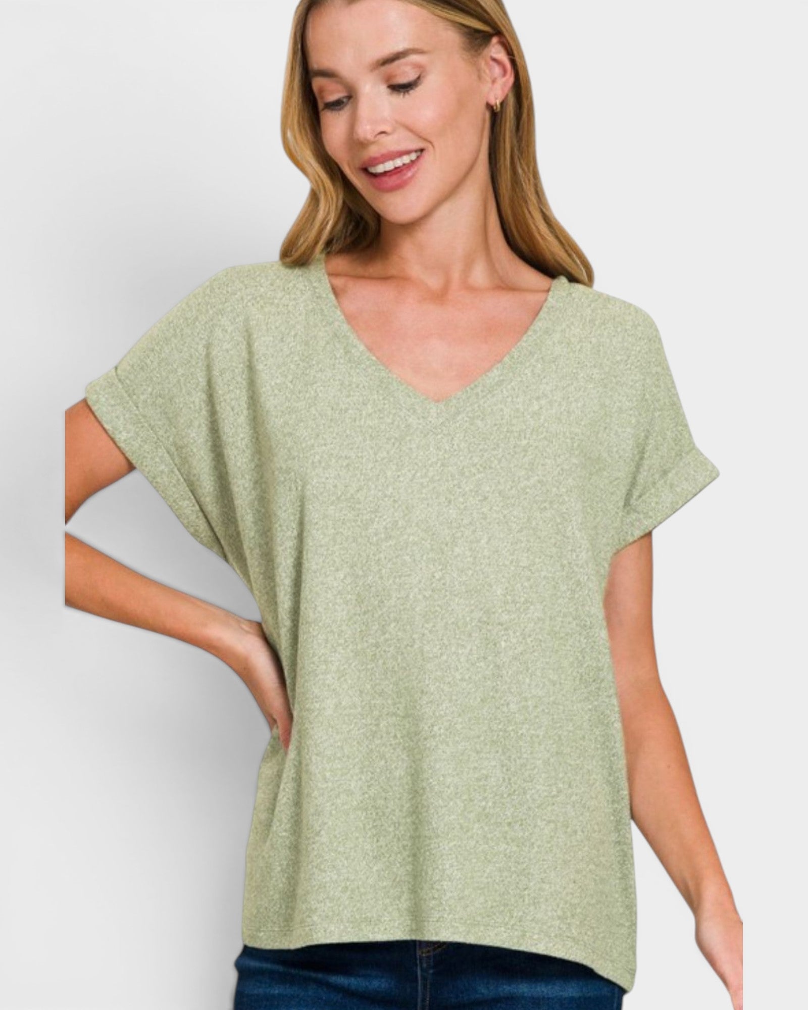 Woman wearing a green oversized t-shirt against a white background