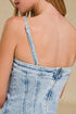 Denim dress with thin straps on a beige background