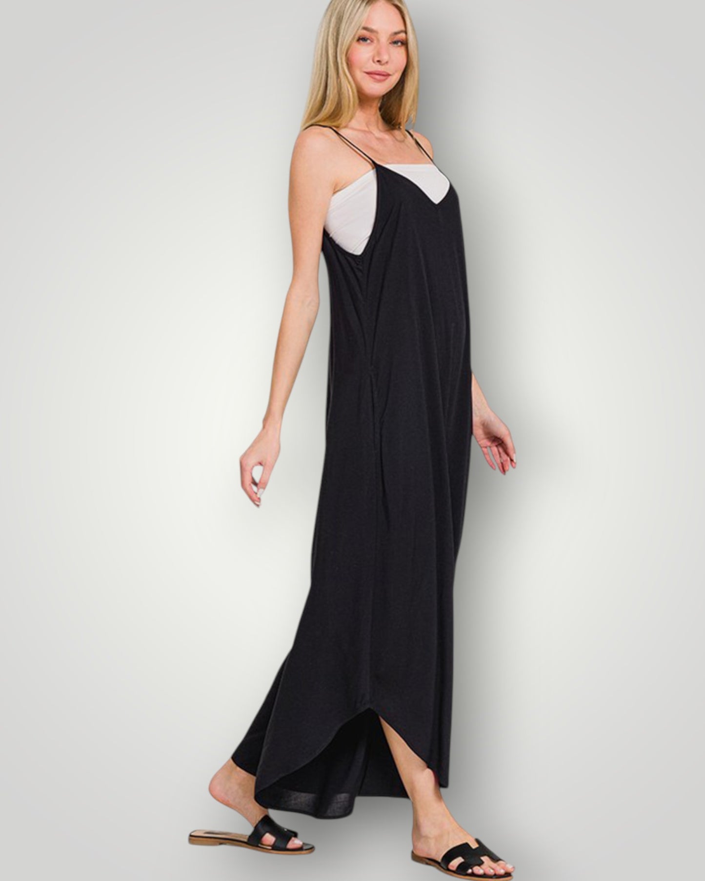 Woman wearing a black and white dress against a plain background