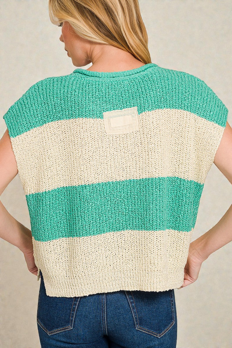 Person wearing a teal and beige striped sweater against a neutral background