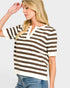 Woman wearing a brown and white striped shirt with a plain background