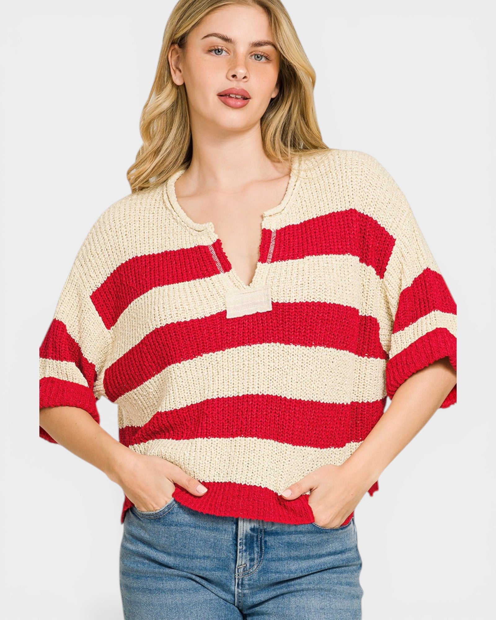 Woman wearing a red and cream striped sweater on a white background