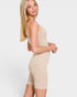 Woman wearing a beige ribbed knit romper on a white background