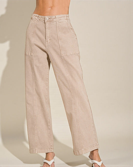 Beige pants worn by a person on a plain background