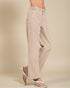 Beige pants worn by a person on a beige background
