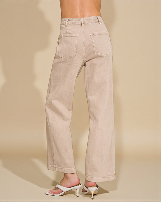 Beige wide-leg jeans worn by a person on a beige background