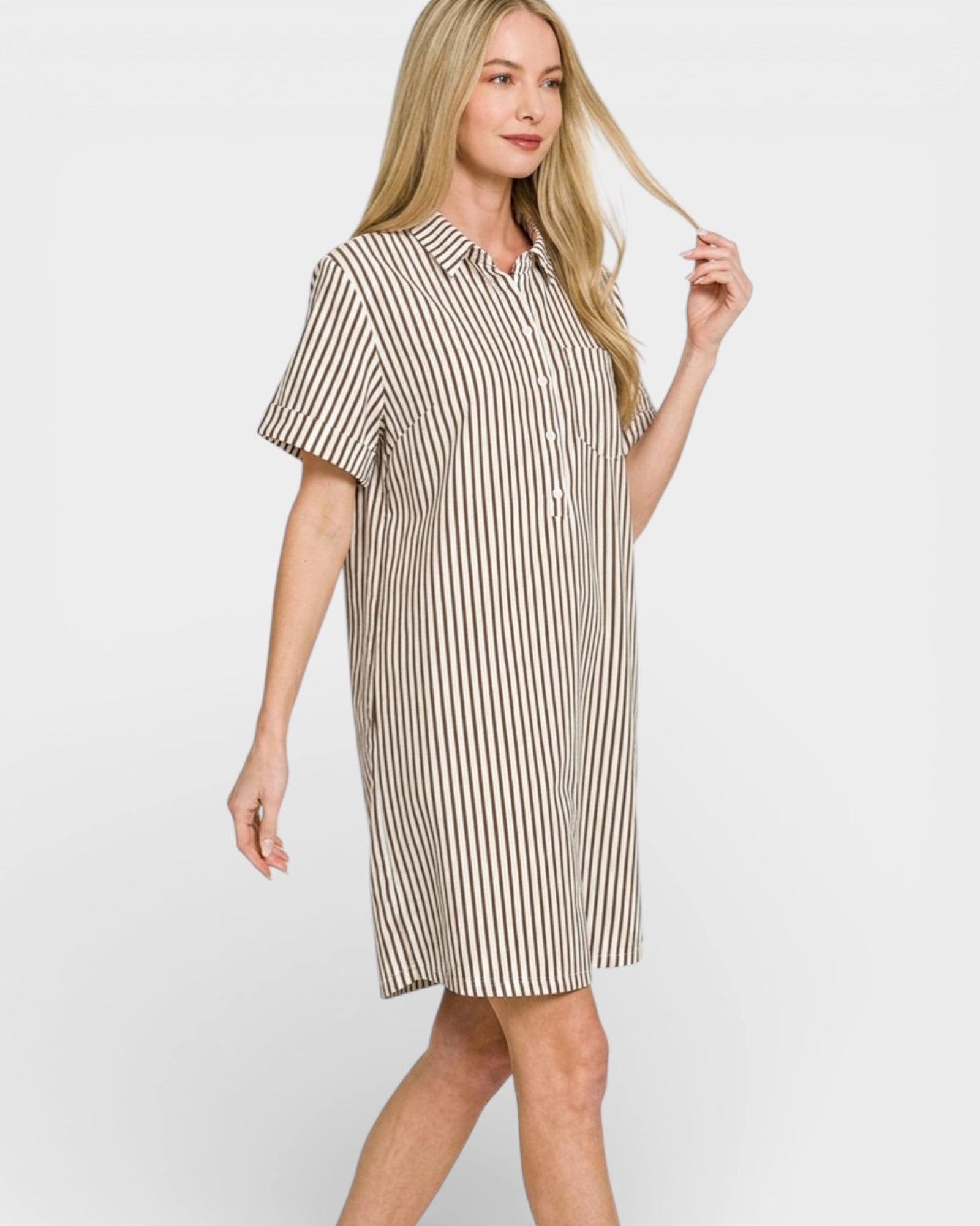 Woman wearing a striped dress on a plain background