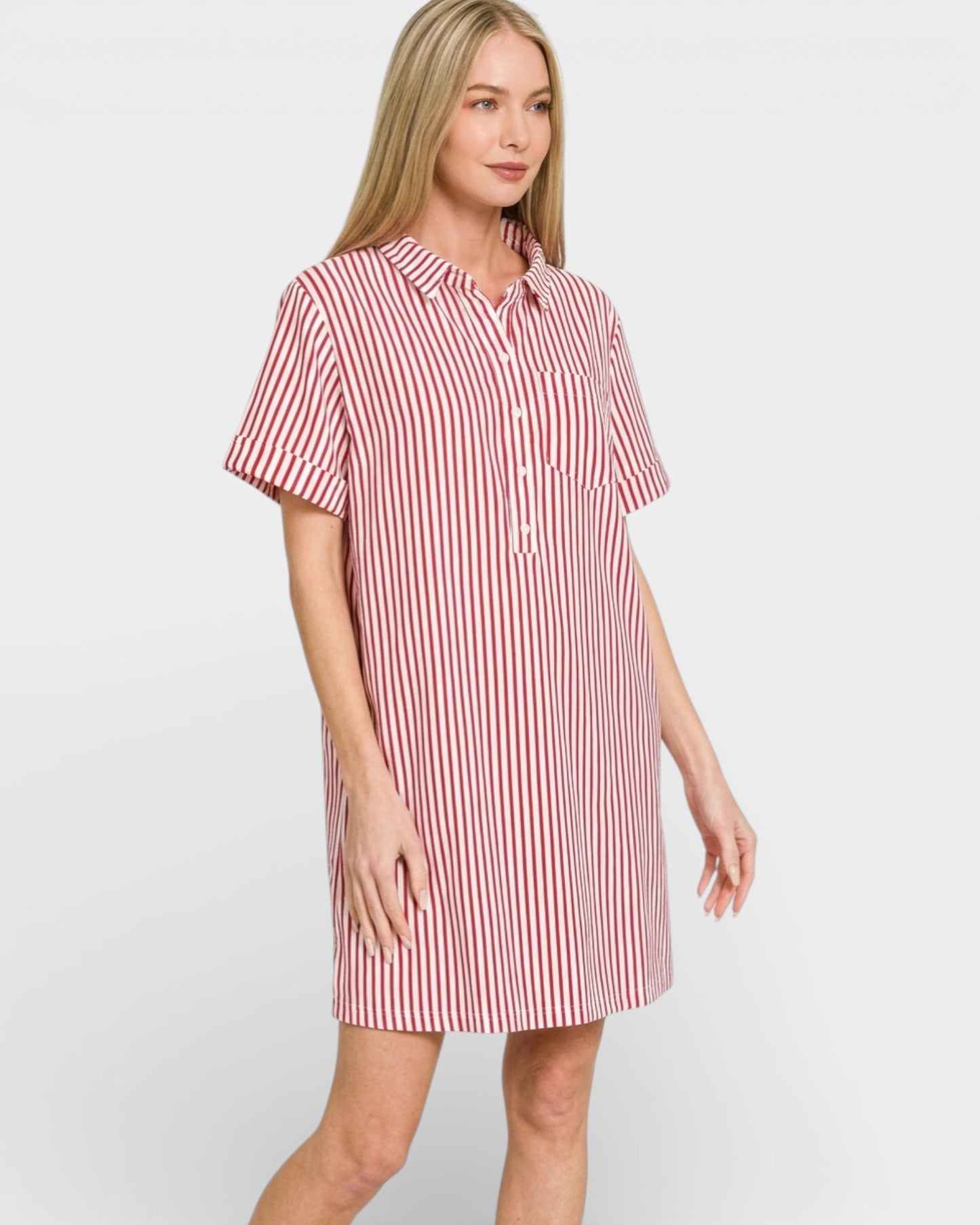 Woman wearing a red and white striped shirt dress on a plain background