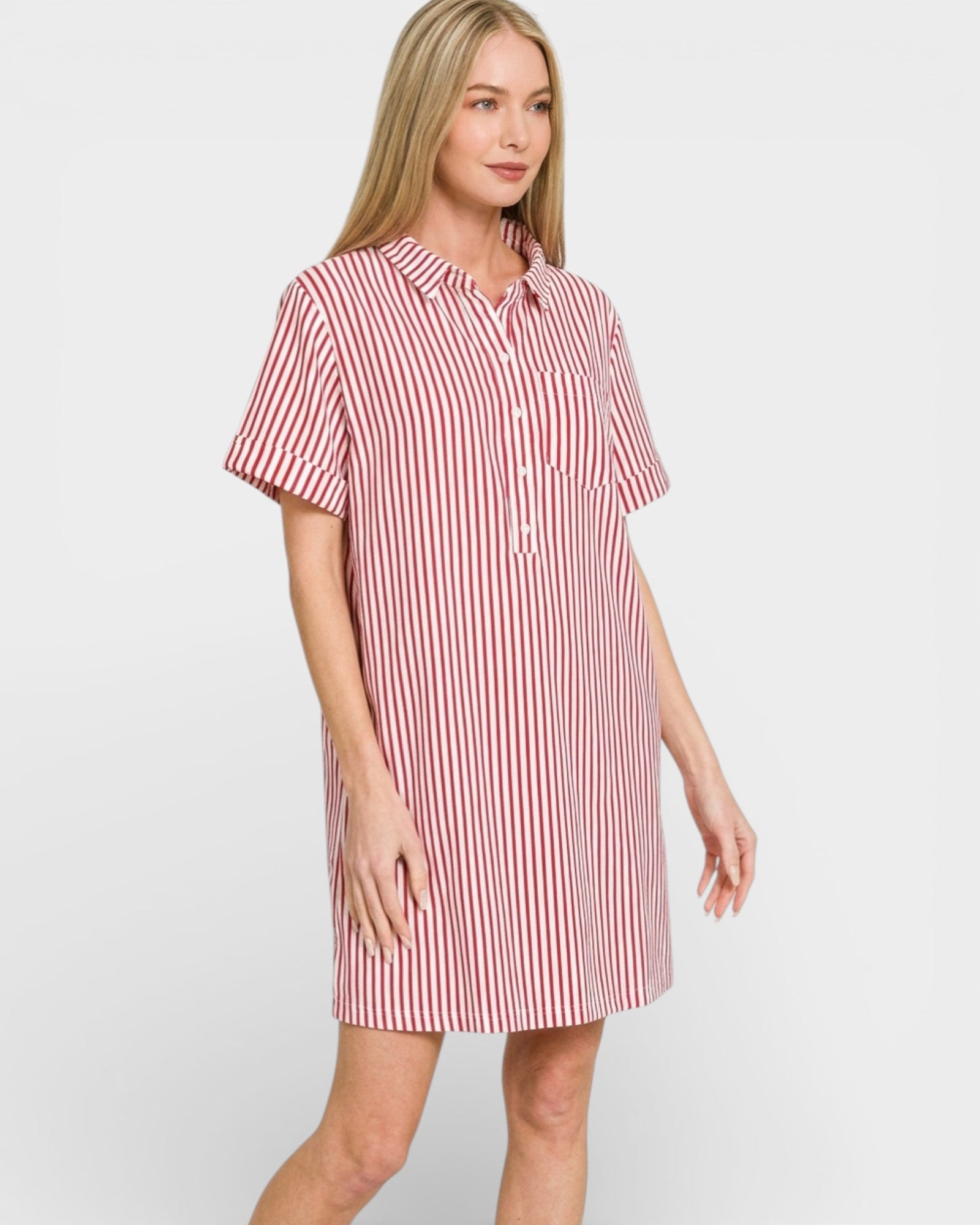 Woman wearing a red and white striped shirt dress on a plain background