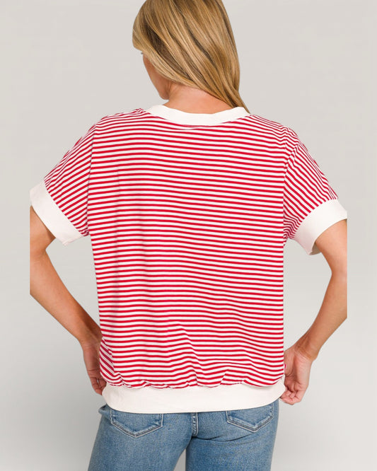 Person wearing a red and white striped shirt with a plain background