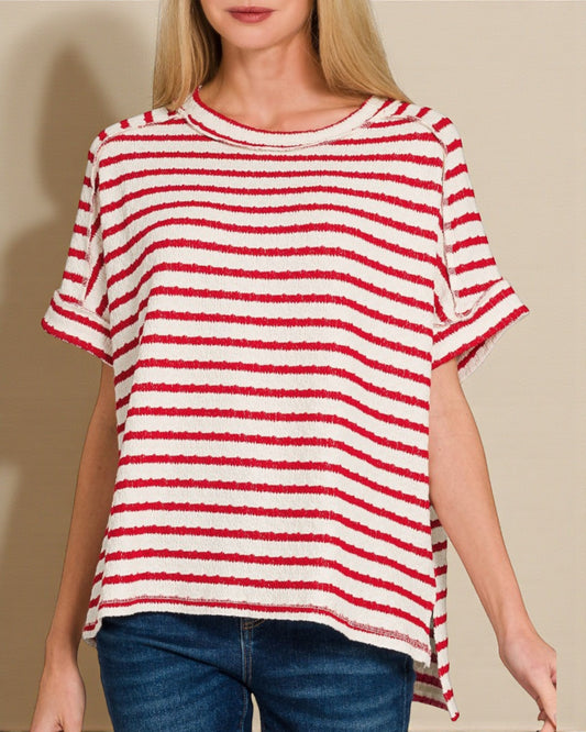 Woman wearing a red and white striped shirt with a beige background