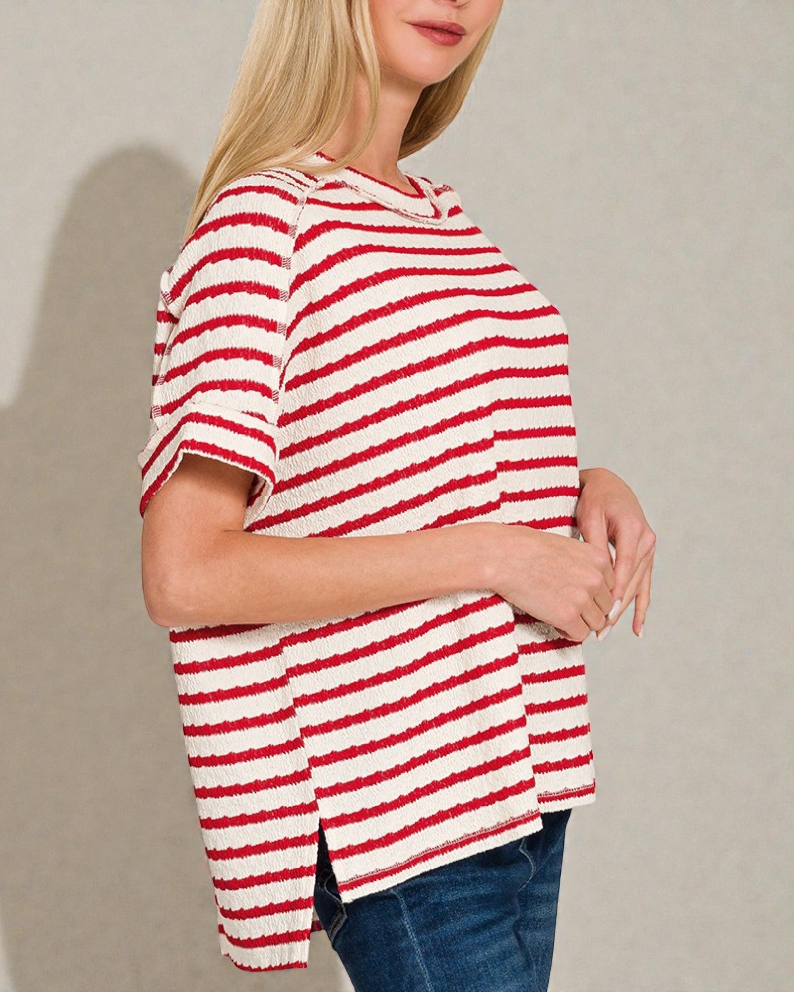 Person wearing a red and white striped shirt against a plain background