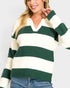 Woman wearing a green and white striped sweater on a plain background