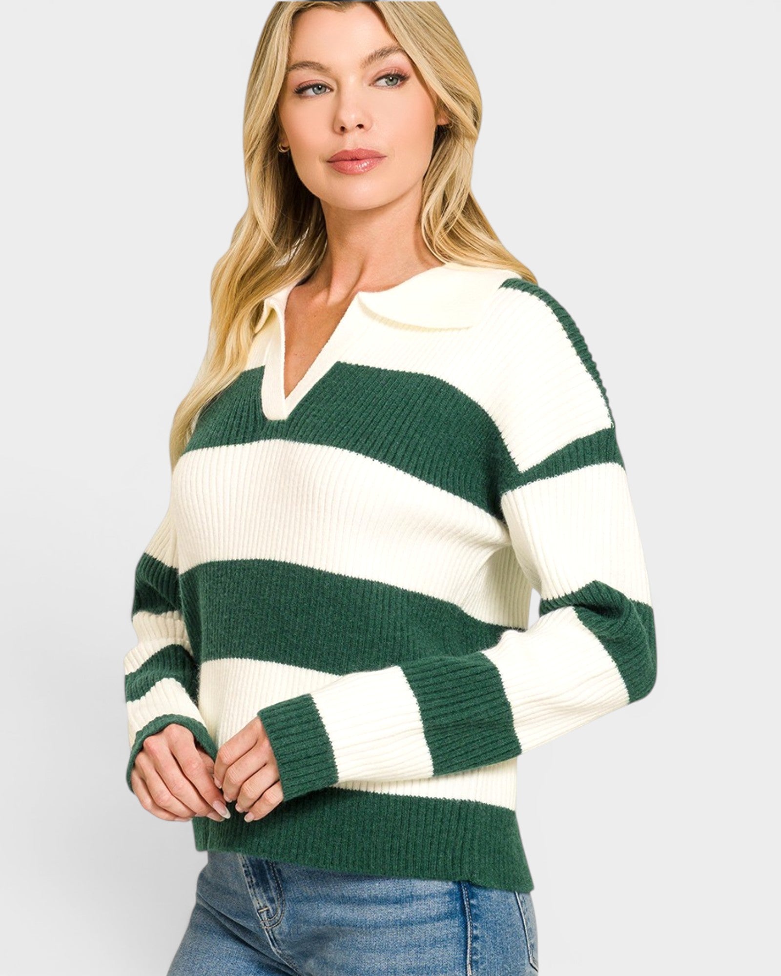 Woman wearing a green and white striped sweater on a light gray background