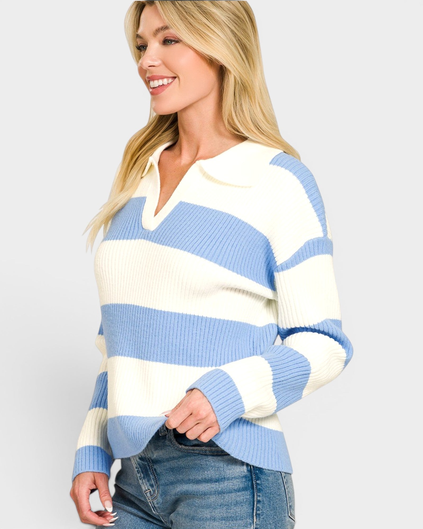 Woman wearing a blue and white striped sweater on a plain background