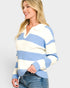 Woman wearing a blue and white striped sweater on a plain background