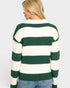 Person wearing a green and white striped sweater on a plain background