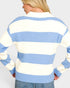 Person wearing a blue and white striped sweater on a plain background