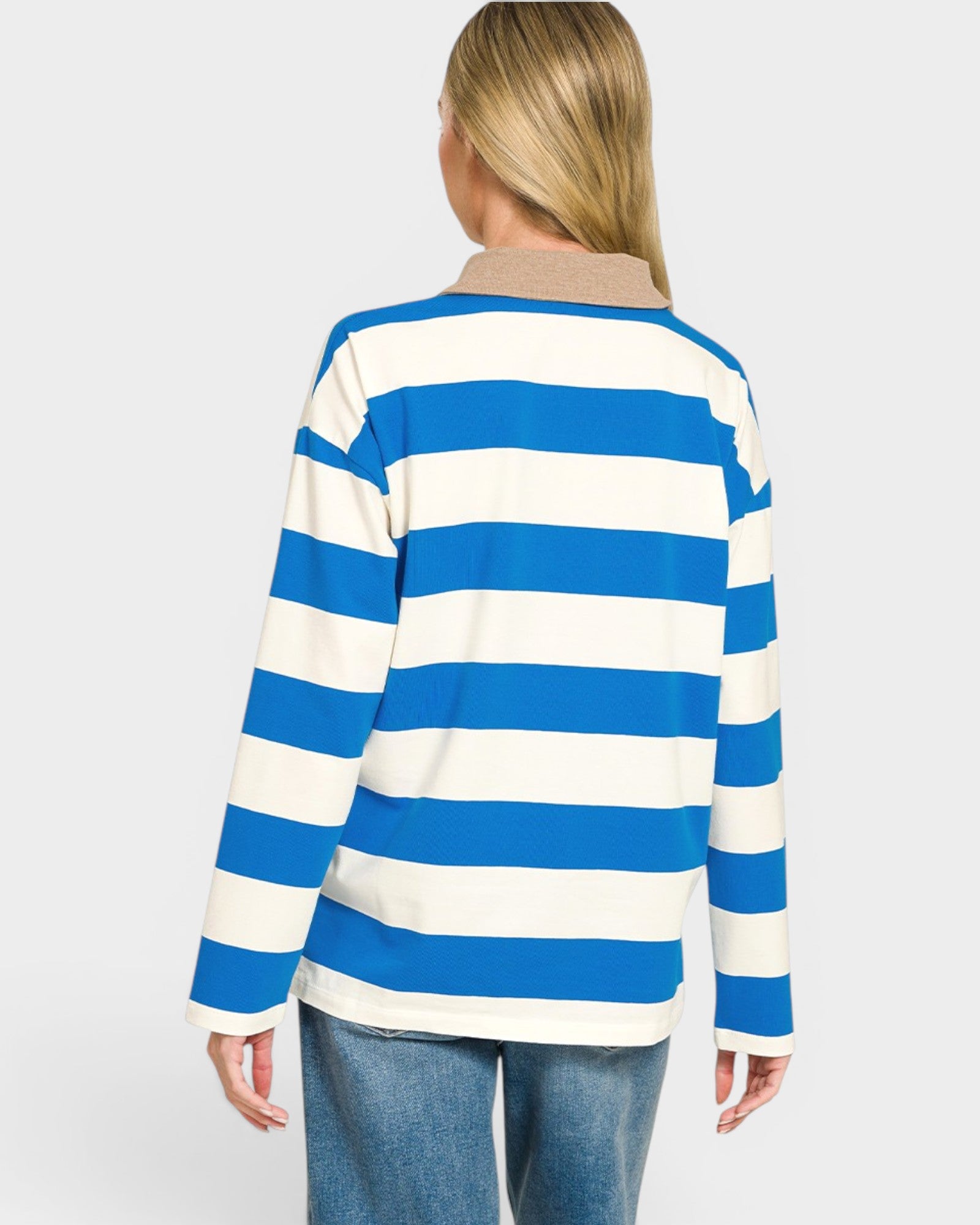 Person wearing a blue and white striped sweater on a plain background