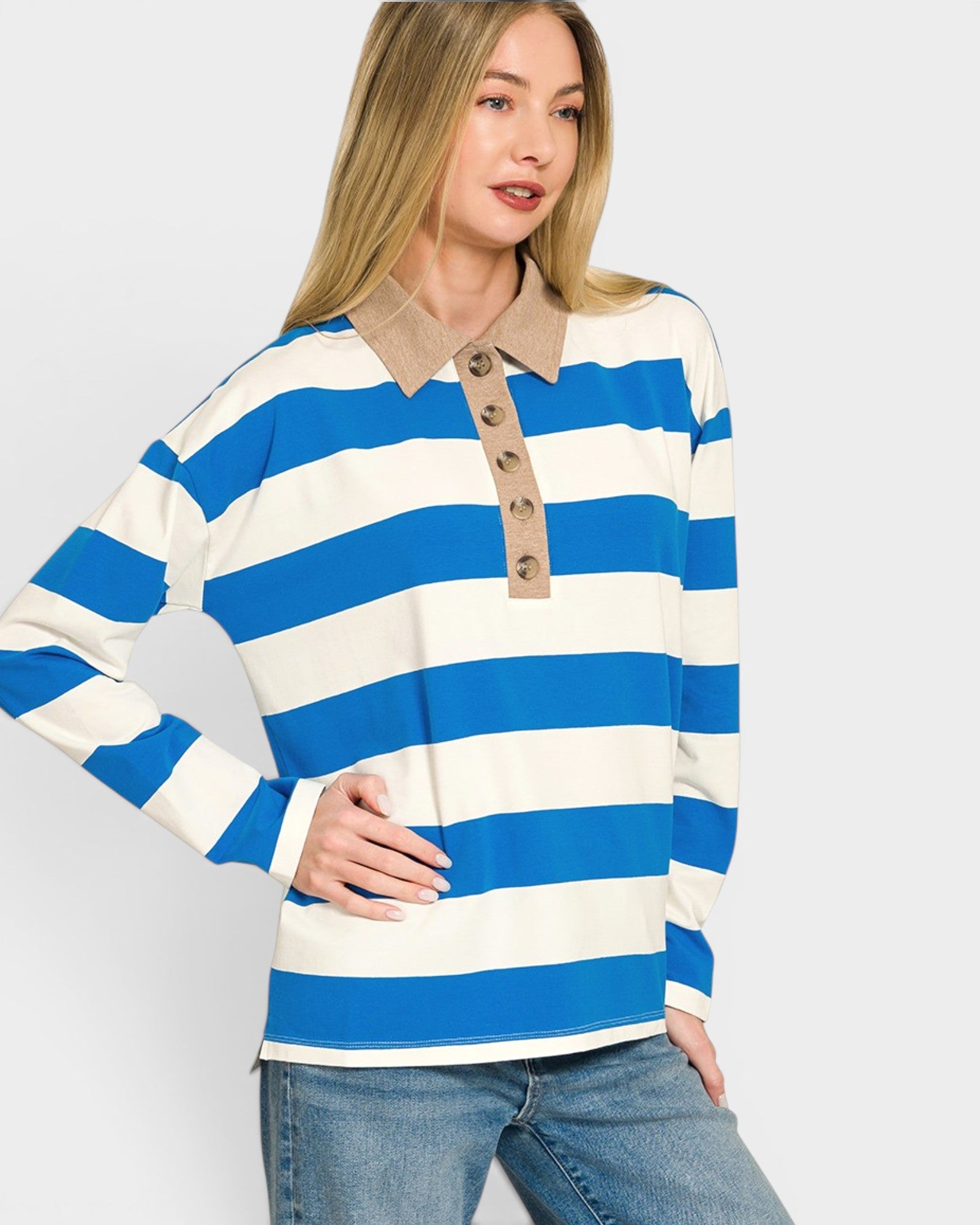 Woman wearing a blue and white striped long-sleeve shirt with a beige collar on a light gray background