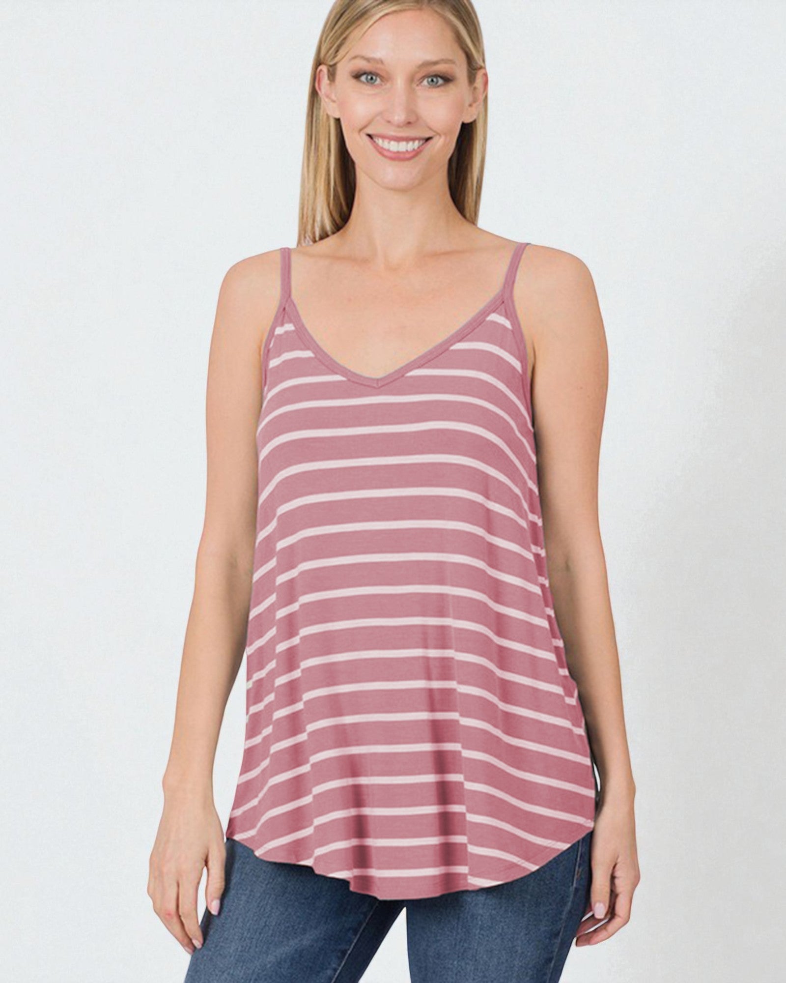 Woman wearing a striped tank top and jeans on a white background