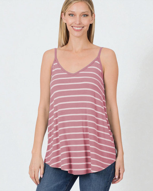 Woman wearing a striped tank top and jeans on a white background