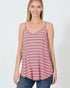 Woman wearing a striped tank top and jeans on a white background