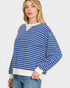 Woman wearing a blue and white striped sweater on a plain background