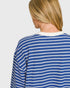 Person wearing a blue and white striped shirt on a plain background