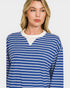 Woman wearing a blue and white striped long-sleeve shirt on a plain background