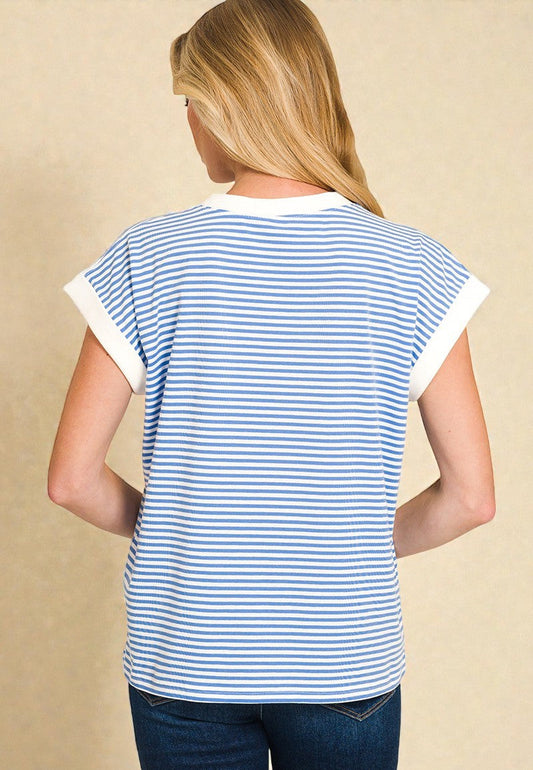 Person wearing a blue and white striped shirt with a beige background