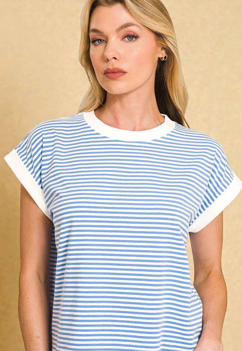 Woman wearing a blue and white striped t-shirt against a beige background