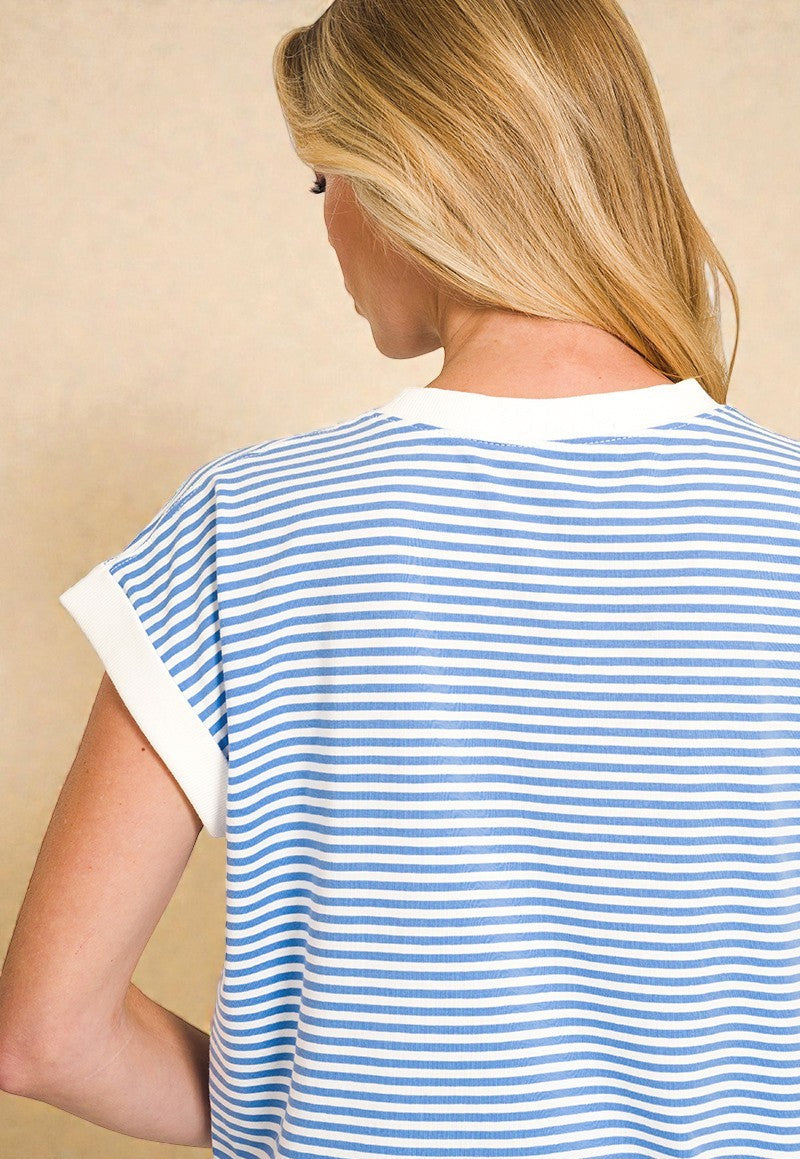 Person wearing a blue and white striped shirt with 'Cornflower Blue' text on a beige background