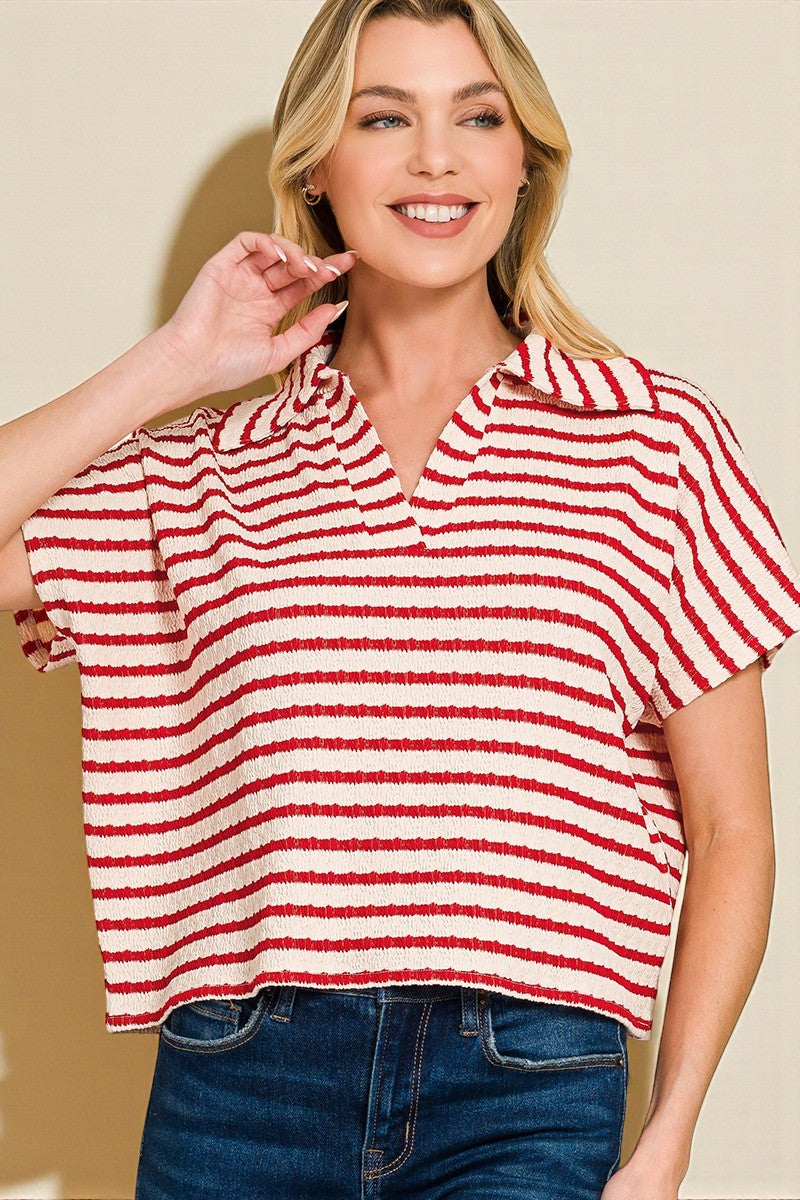 Woman wearing a red and white striped shirt against a beige background