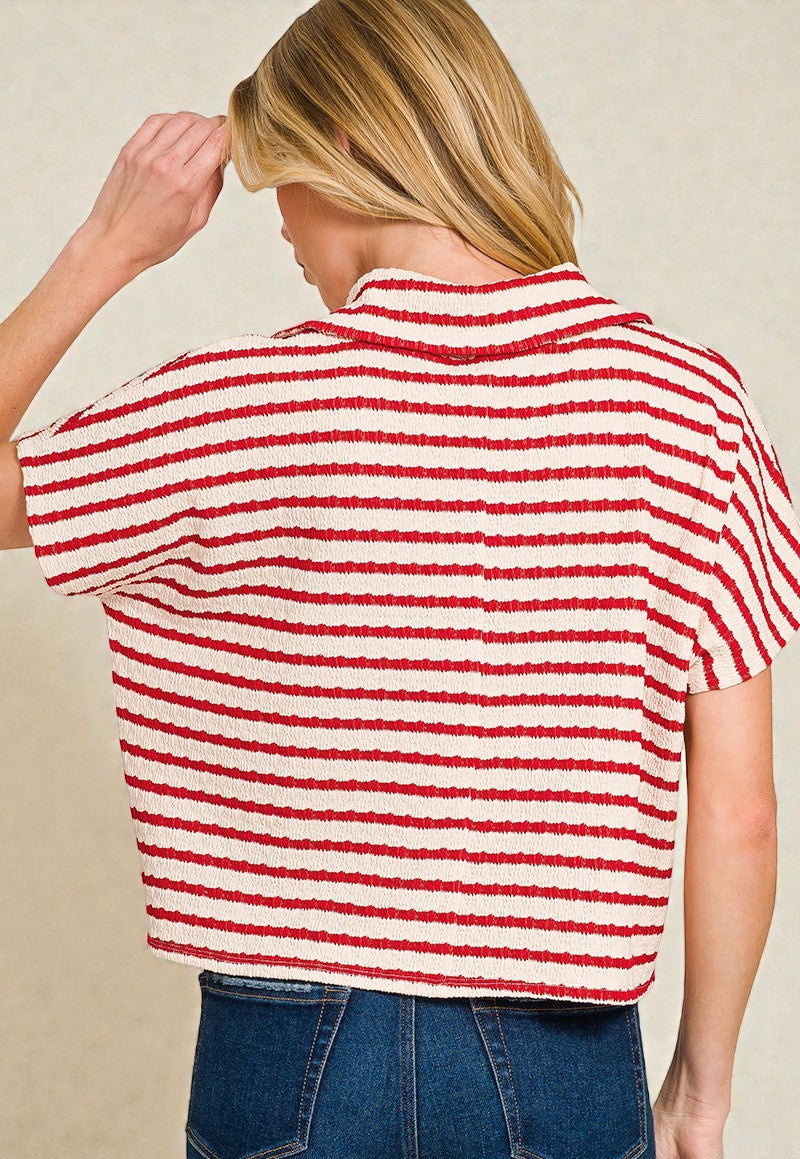 Person wearing a red and white striped shirt with a beige background