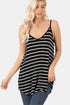 Woman wearing a black and white striped tank top against a plain background