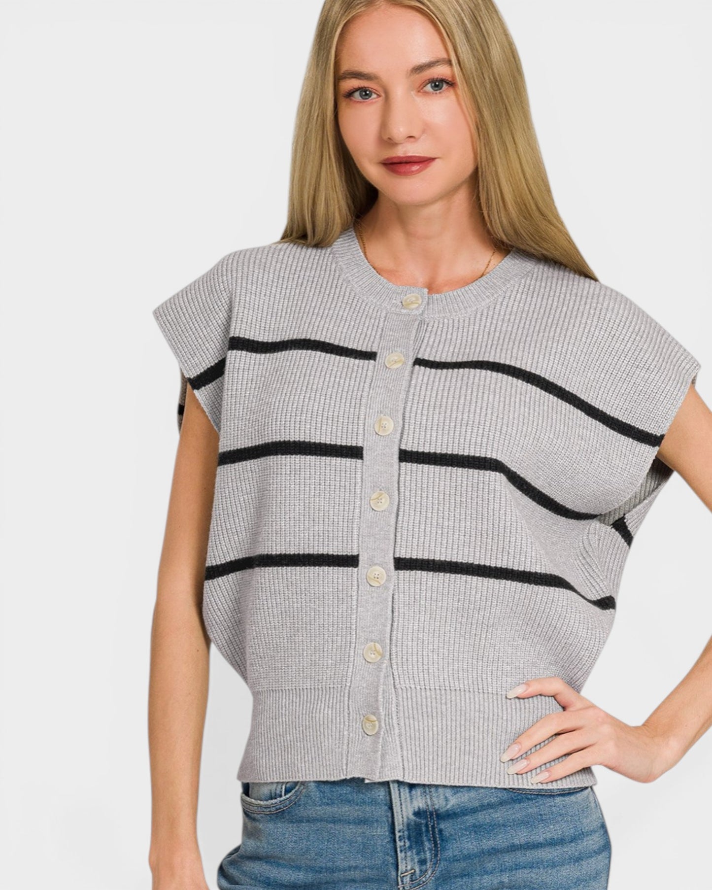Woman wearing a gray cardigan with black stripes on a white background