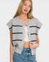 Woman wearing a gray cardigan with black stripes on a white background