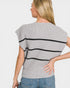 Woman wearing a gray sweater with black stripes on a plain background