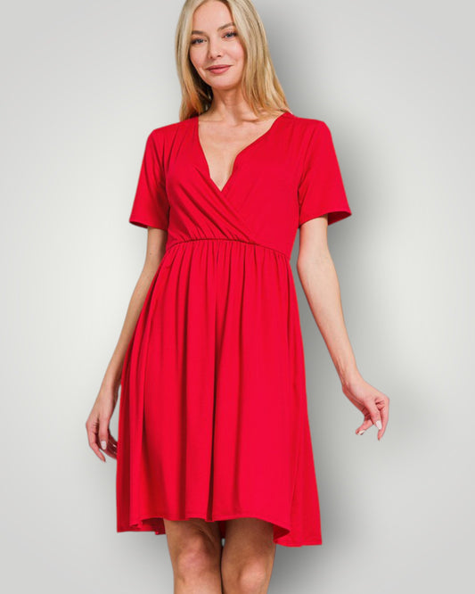 Woman wearing a red dress against a plain background