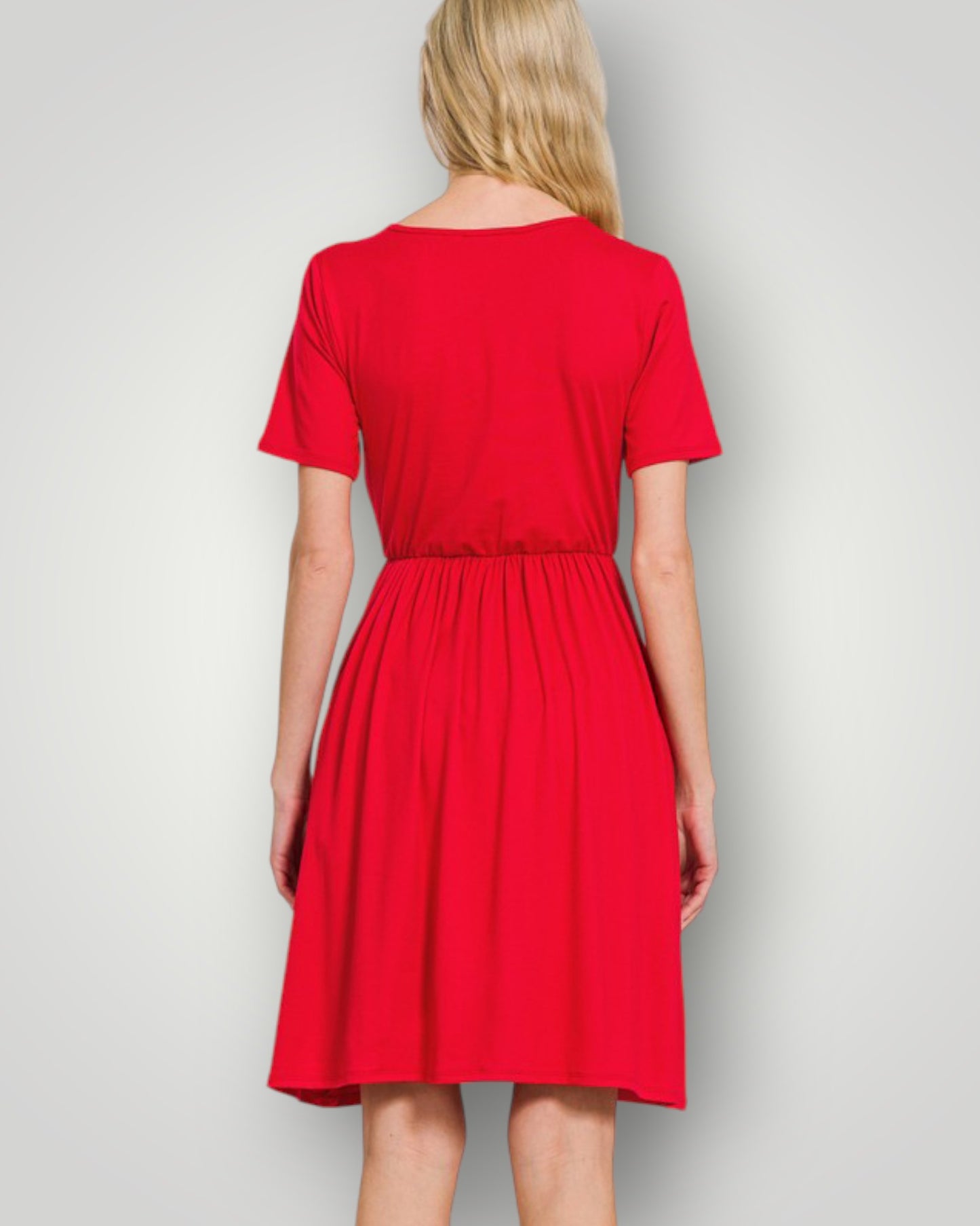 Red dress worn by a person on a plain background